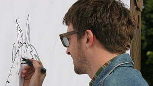 brown haired man wearing blue denim jacket