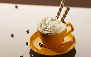 brown ceramic teacup and saucer filled with wafer stick and whip cream HD wallpaper