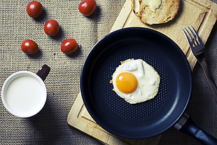 black and yellow plastic container, food, eggs, tomatoes