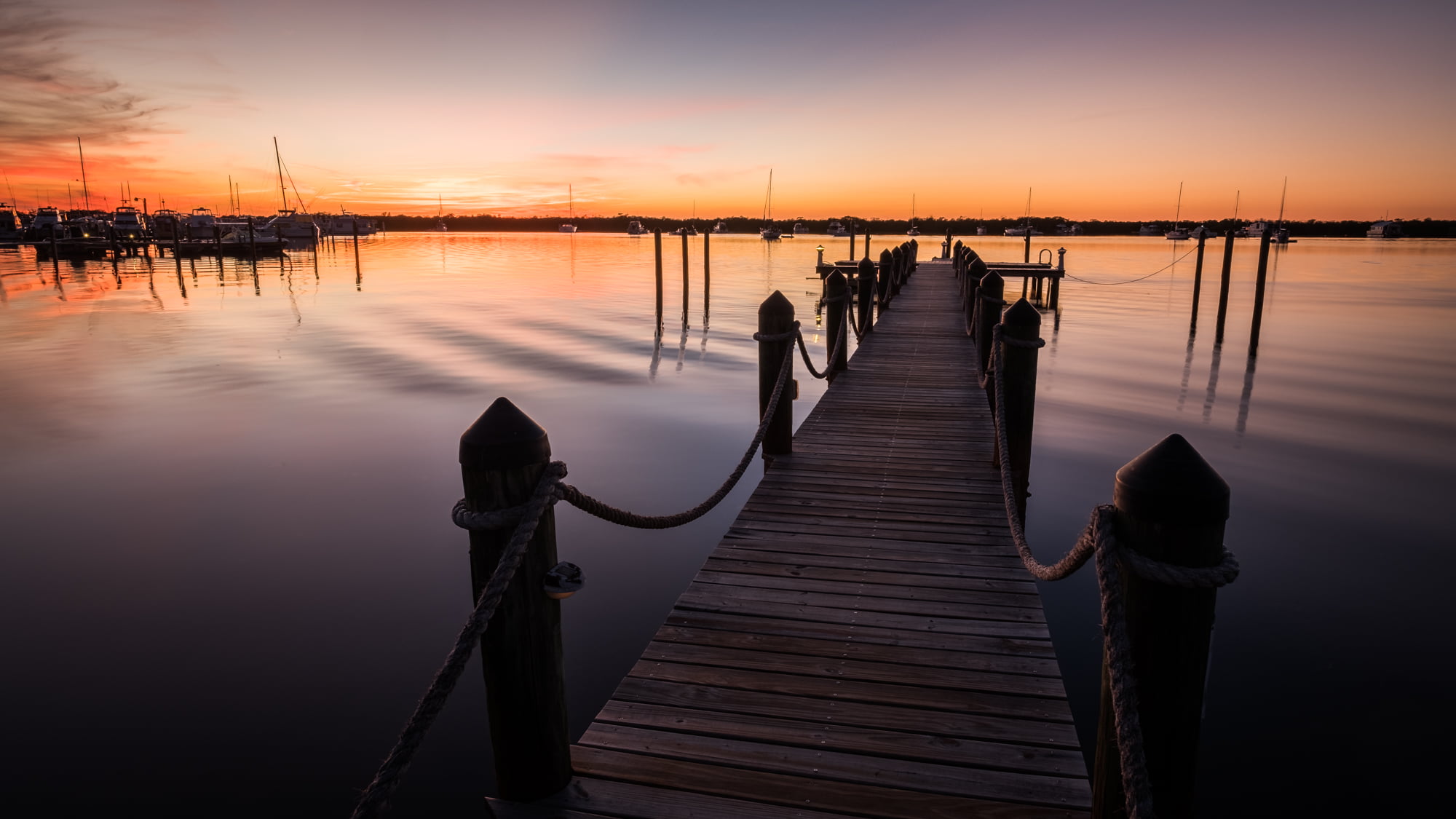 gray wooden dock under gray sky, florida