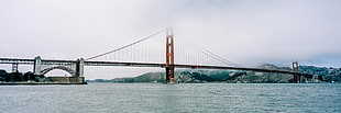 brown and gray bridge near mountain