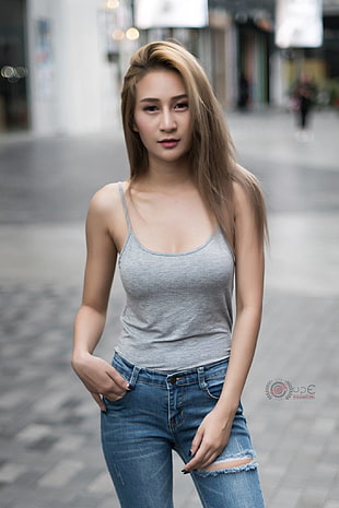 selective focus photo of woman wearing gray spaghetti strap