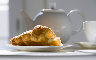 baked bread near white teapot