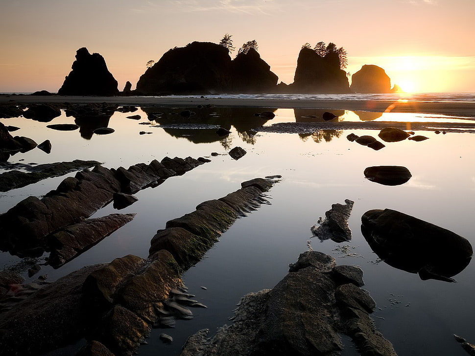white body of water with rock formation during sunset HD wallpaper