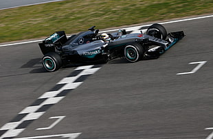 silver and black Mercedes-Benz Petronas F1 racing car crossing the finish line HD wallpaper