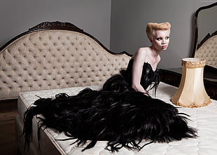 woman wearing black sweetheart neckline dress while sitting on bed HD wallpaper