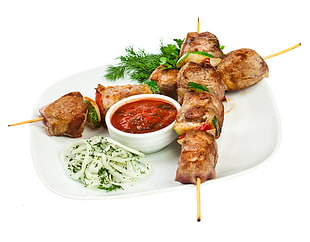 grilled food with sauce on white ceramic plate