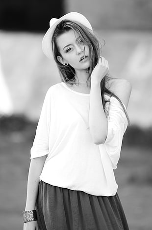 grayscale photography of girl wearing off-shoulder shirt and black bottoms