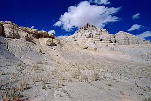 brown mountains under cloudy sky