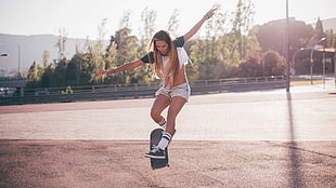 woman wearing white crop top playing skateboard