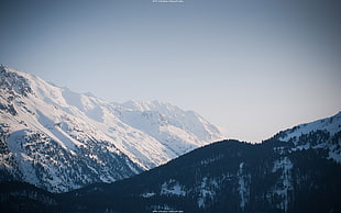 a view of snowy mountains under bright sky