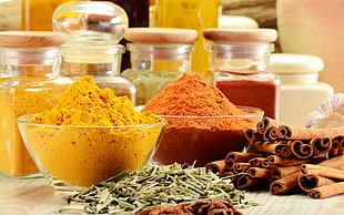 assorted-color powders in clear glass bowls and assorted glass canisters