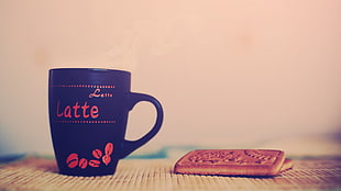 black and red Latte print ceramic mug with two biscuits on brown surface HD wallpaper