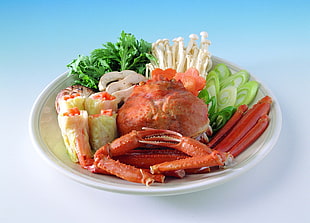 cooked crab on plate with vegetables