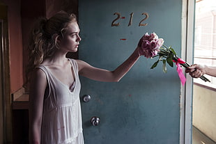 woman in white sleeveless dress holding pink rose flower HD wallpaper