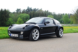 black coupe on gray road