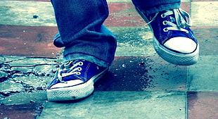 photo of person feet wearing black-and-white shoes