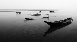 brown wooden boat on body of water in gray scale photo HD wallpaper