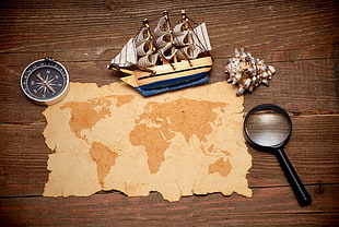 sailing ship, magnifying glass, conch shell, compass and map HD wallpaper