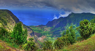 mountain range under clouds during daytime