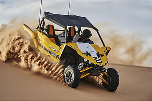 white and yellow dune buggy running on dessert