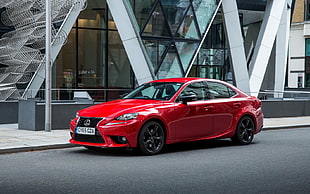 red Lexus sedan parked near building