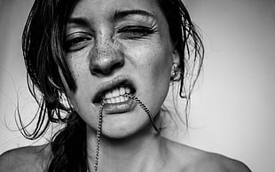 woman with freckles biting chain necklace HD wallpaper