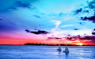 landscape photography of a two sailboats in bodies of water HD wallpaper