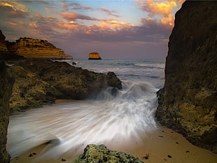 time lapse photography of water falls on the sea