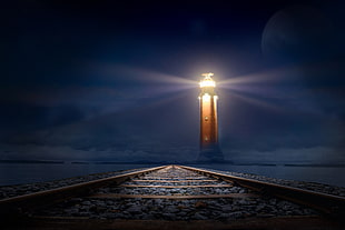 light house near trail rail during nighttime HD wallpaper