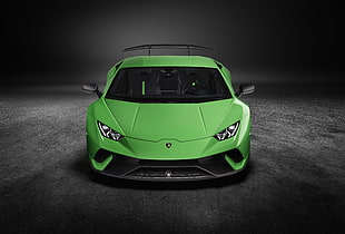 green sports car on black road