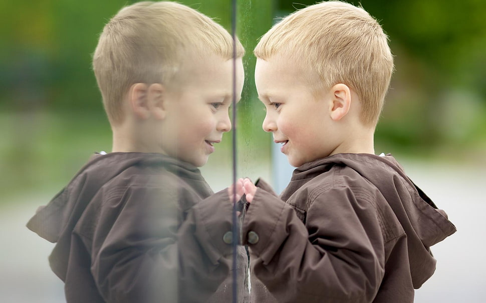 boy in brown jacket facing mirror HD wallpaper