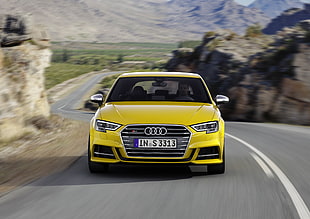 yellow Audi car on black top road during daytime HD wallpaper