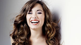 woman smiling with long brown curly hair