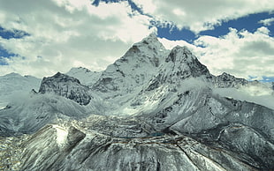 landscape photo of mountain filled with snow under nimbus clouds background