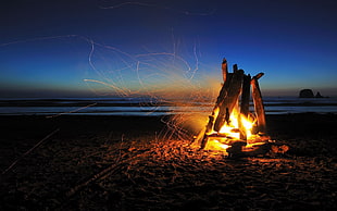 fire pit on seashore at nigh time HD wallpaper