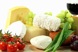 green grapes and tomatoes on top of brown table