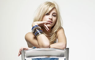 blonde-haired woman sitting on steel chair wearing bangles HD wallpaper
