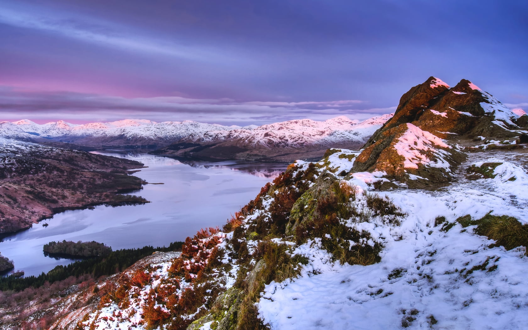 aerial photography of snow covered mountains near body of water during daytime