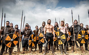 photography of soldiers with sword and shield during daytime