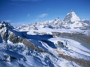 mountains covered with snow under blue sky during daytime