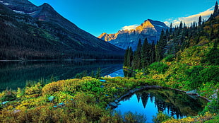 body of water between mountain during daytime