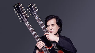 man in black long-sleeved shirt holding guitar HD wallpaper