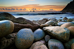 gray rocks near body of water