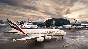 white Fly Emirates airplane on asphalt road HD wallpaper