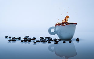 photo of white teacup filled with coffee beside spilled coffee beans HD wallpaper