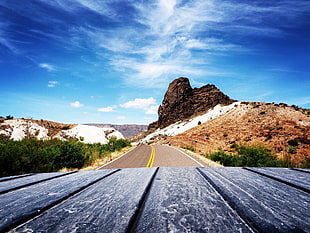 Scenic View of Mountain Road Against Blue Sky HD wallpaper