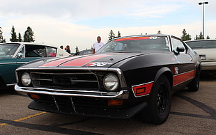 black and red classic coupe during daytime