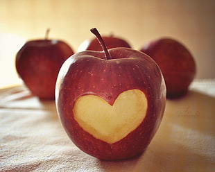 Apple fruit with carved heart-shape photography HD wallpaper