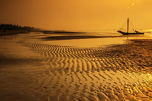 beach shore with sail boat during golden time HD wallpaper